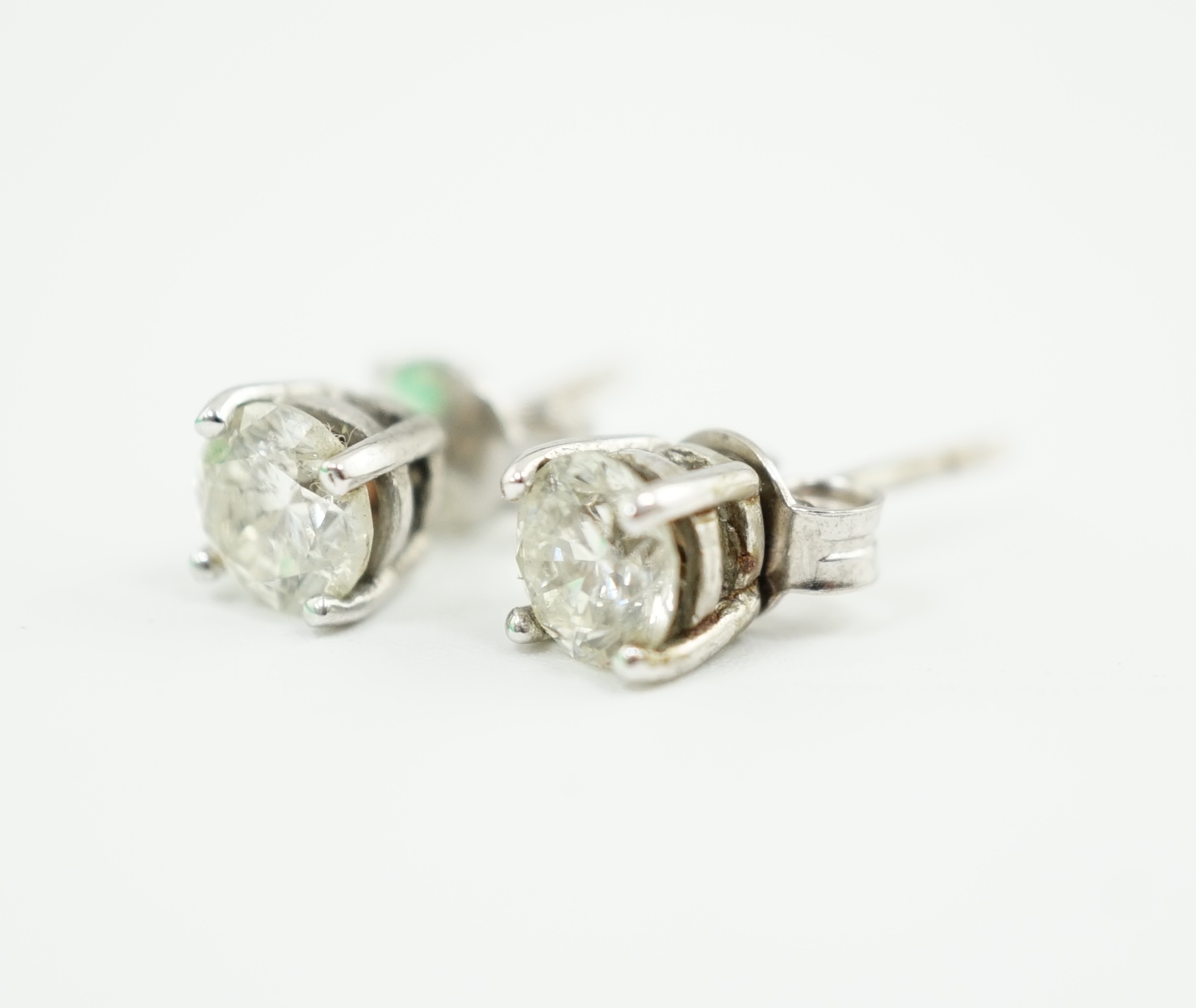 A pair of 18k white gold and solitaire diamond set ear studs